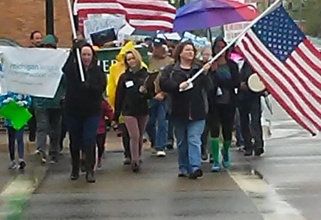 Activists with flags lead Kalamazoo People's Climate March